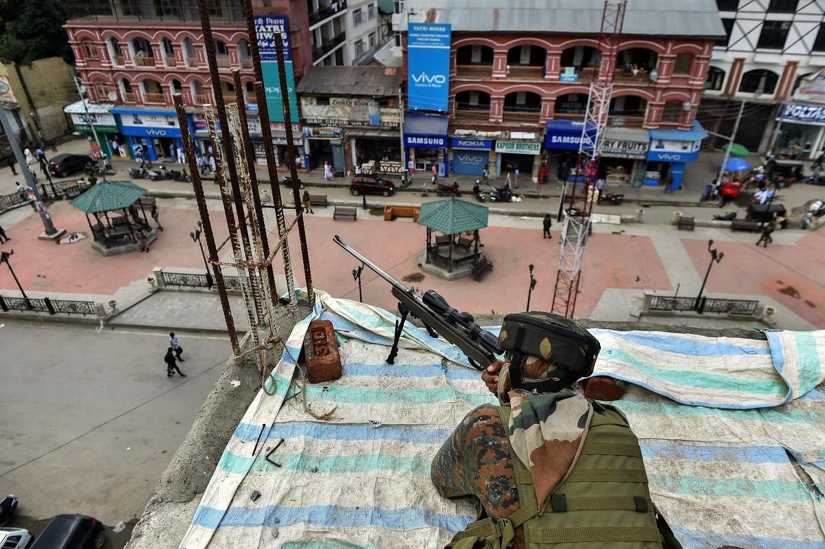 Srinagar: A CRPF personal takes a position on the top of a building during a search operation at Lal Chowk, in Srinagar on Friday, July 27, 2018. Security has been on high alert after recent attacks by suspected militants in Srinagar. (PTI Photo/S Irfan)