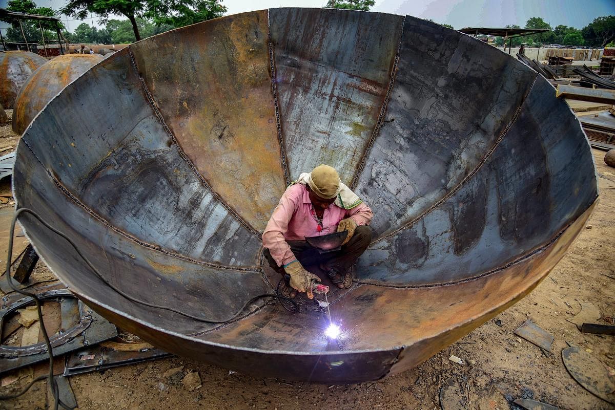 A labourer works at a pontoon factory where pontoons are being manufactured for the upcoming Kumbh Mela 2019. (PTI Photo)