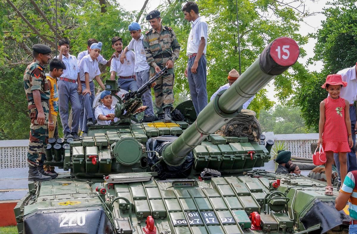 School students have a look of an army weapon during 'Know Your Army' exhibition at the Amritsar Cantonment area in Amritsar. (PTI Photo)