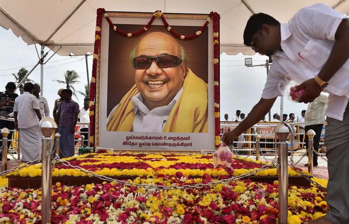 People pay homage to late DMK patriarch M Karunanidhi at his memorial on Marina Beach, in Chennai on Monday, Aug. 13, 2018. (PTI Photo)