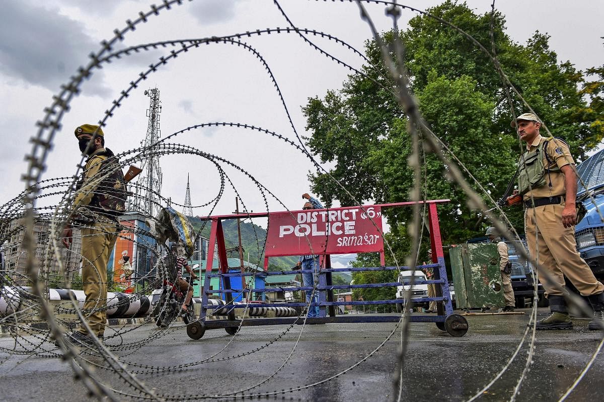 Security personnel stand guard on a blocked road during the full dress rehearsal for Independence Day at Shere-e-Kashmir stadium, in Srinagar, on Monday, August 13, 2018. ( PTI Photo)