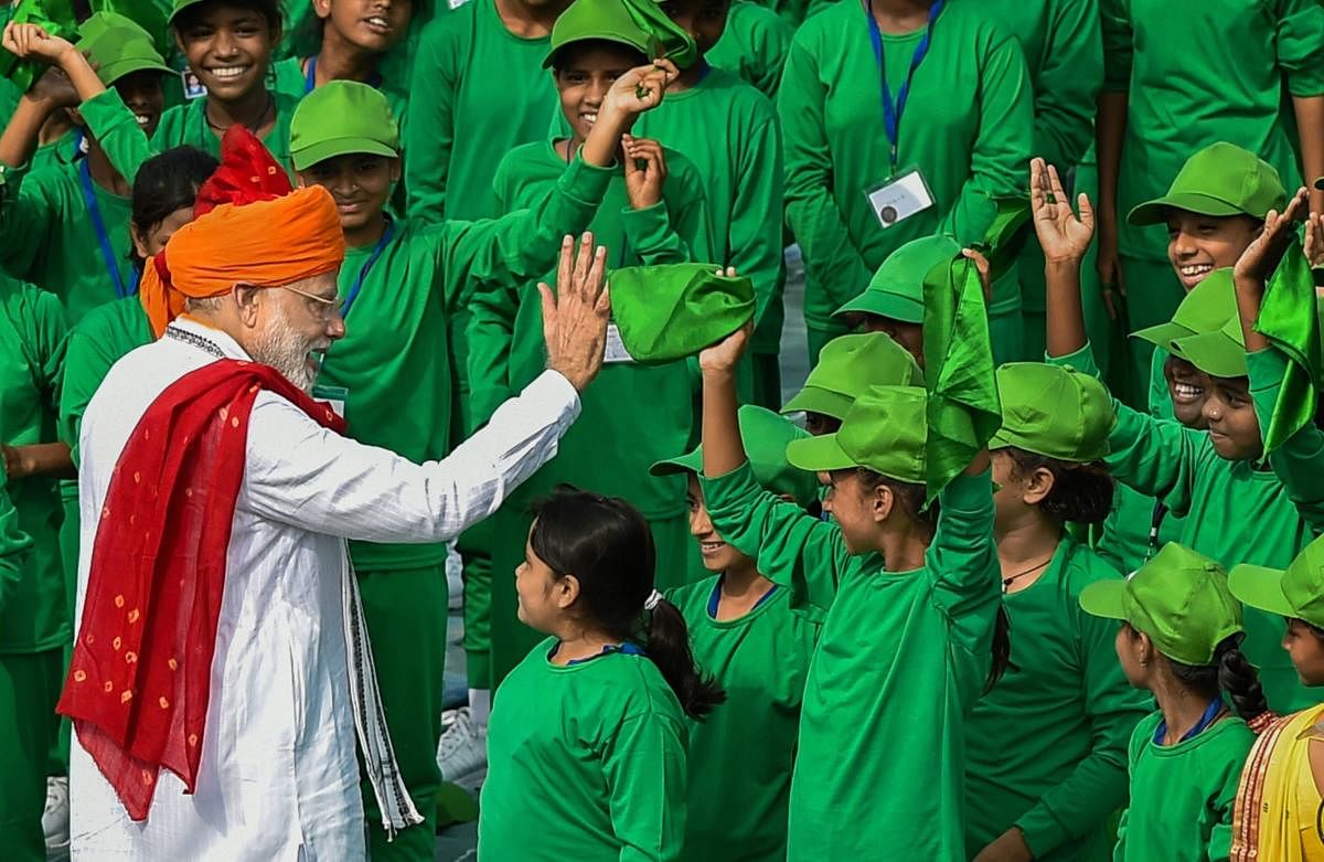 Prime Minister Narendra Modi interacts with children during Independence Day celebrations at the Red Fort, in New Delhi on Wednesday, August 15, 2018. (PTI Photo)