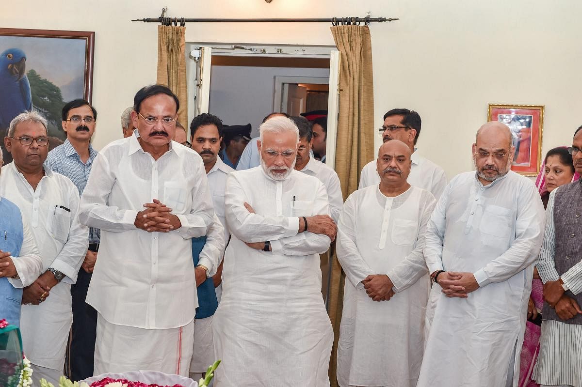Prime Minister Narendra Modi, Vice President Venkaiah Naidu and BJP President Amit Shah stand with others as they tribute to former prime minister Atal Bihari Vajpayee, at his Krishna Menon Marg residence, in New Delhi on Thursday, Aug 16, 2018. PTI photo