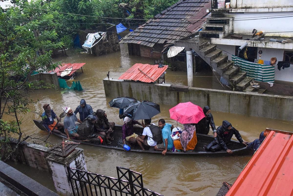 Rescue officials assist villagers out of a flooded area, following heavy monsoon rainfall, near Kochi on Wednesday, Aug 15, 2018. (PTI Photo)