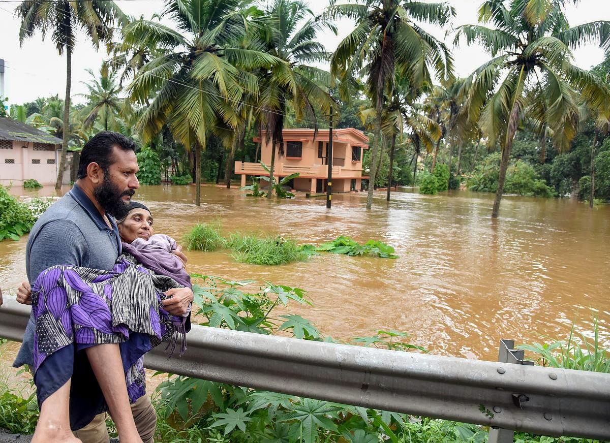 People being rescued from a flood-affected region following heavy monsoon rainfall, in Kochi on Thursday, Aug 16, 2018. (PTI Photo)