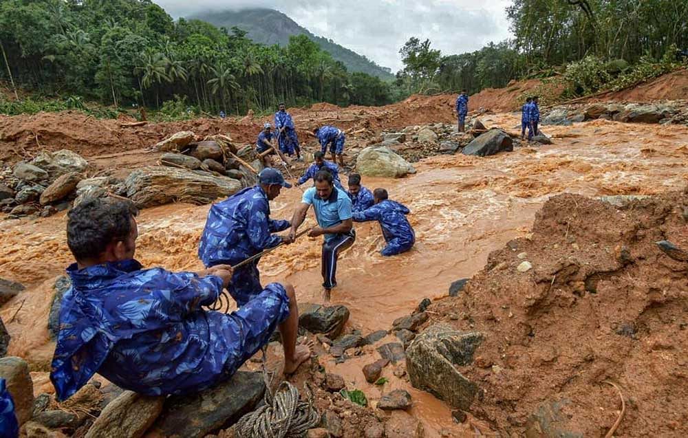 Rescue workers search for the bodies of missing persons after a landslide, triggered by heavy rains and floods, at Nenmara in Palakkad on Friday, Aug 17, 2018. 10 people have reportedly died in the mishap. PTI Photo