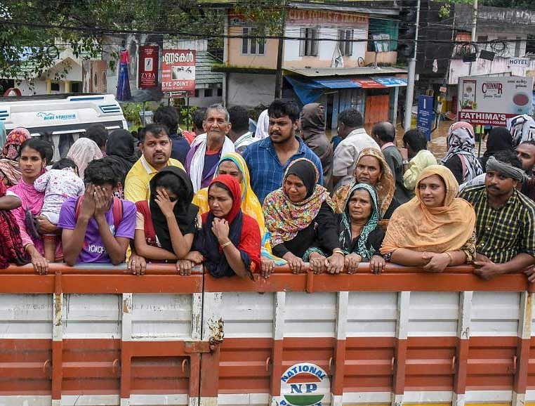 People being rescued from flood-affected regions and taken to shelter camps in trucks following heavy monsoon rainfall, in Kochi. PTI Photo