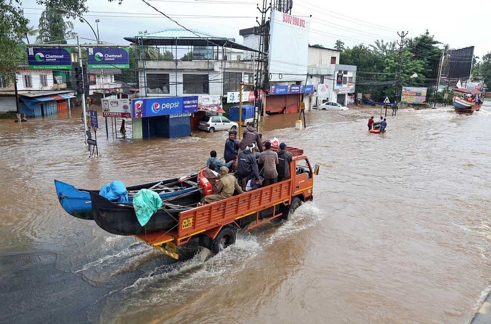 A supply truck transporting boats to flooded areas moves through a water-logged road in Aluva in the southern state of Kerala. Reuters Photo