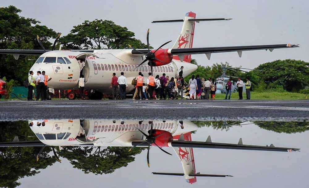 The passenger plane of Alliance Air that landed at INS Garuda naval base in flood-hit Kochi, Kerala. PTI Photo