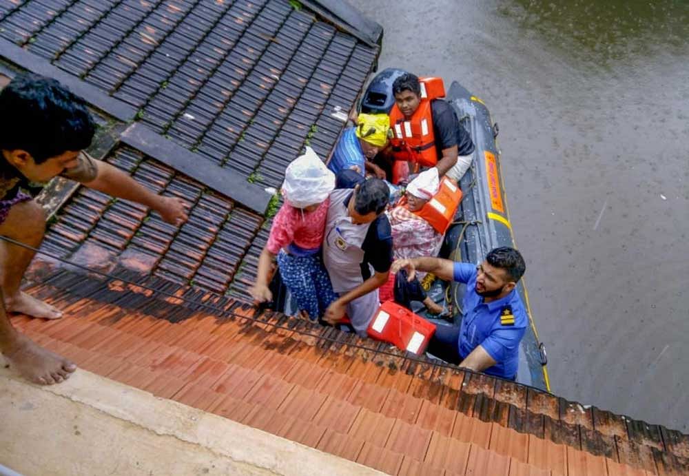 Rescue teams evacuate people from flood affected areas, to relief camps at Kottayam district in Kerala. PTI