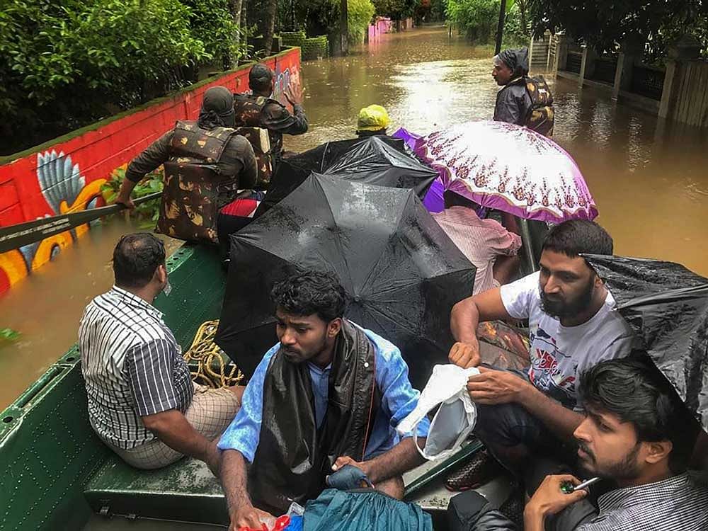 India Army personnel rescue flood affected people in Ernakulam district of Kerala. PTI Photo