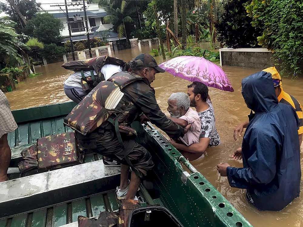 India Army personnel rescue flood affected people in Ernakulam district of Kerala. PTI Photo