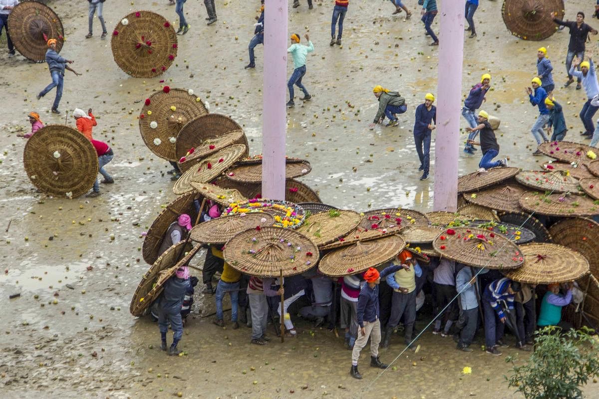 People celebrate the stone-pelting 'Bagwal' festival at a village in Champawat district of Uttarakhand on Sunday, Aug 27, 2018. PTI