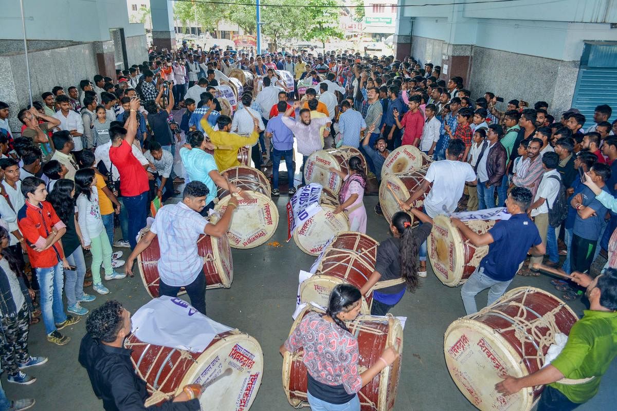 A Dhol Tasha Pathak performs to create awareness about the cleanliness of the stand area in Karad, Maharashtra on Monday, Aug 27, 2018. PTI