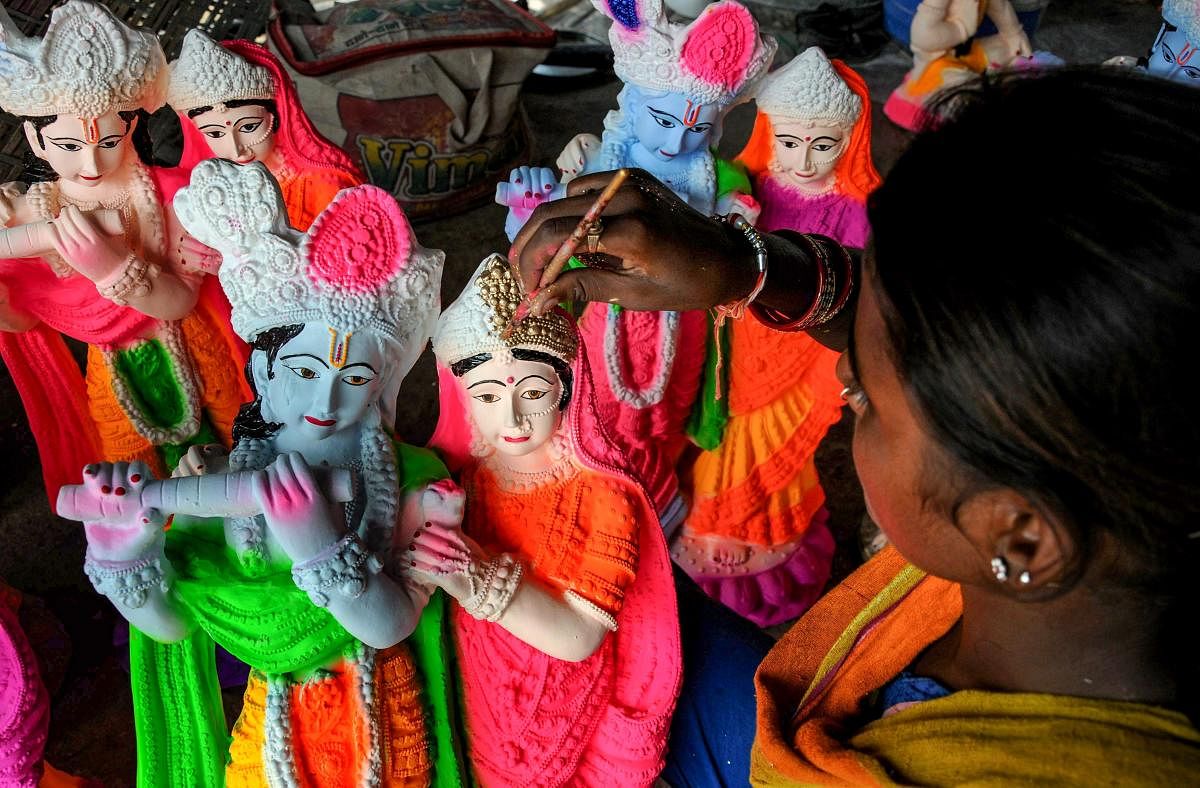 An artist paints an idol of Radha Krishna at a roadside workshop, ahead of the Janmashtami or Gokulashtami festival, in Amritsar on Monday, August 27, 2018. PTI