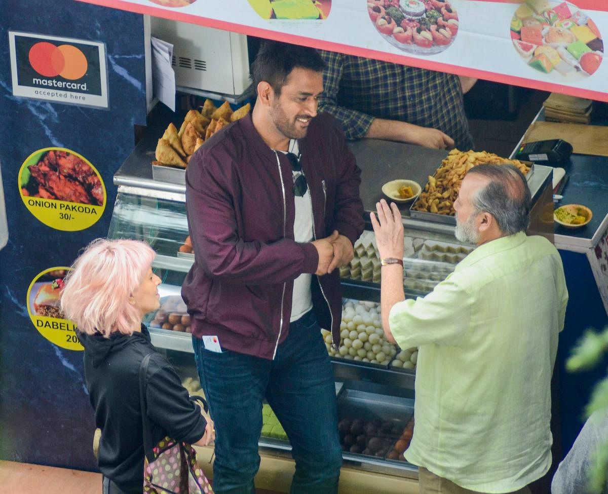 Cricketer M S Dhoni and bollywood actor Pankaj Kapoor during a commercial shoot at Mall Road in Shimla on Tuesday, Aug 28, 2018.