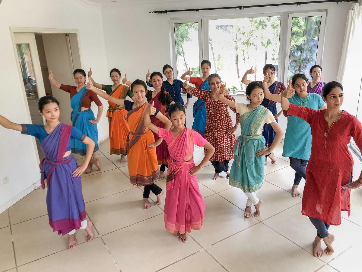 Bharatanatyam exponent Leela Samson (R) teaches dance skills to a group of enthusiasts in Beijing. PTI