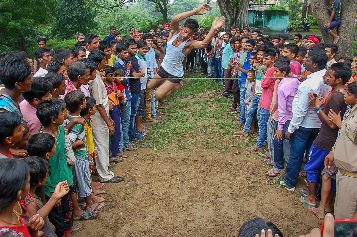 A participant attempts during a high jump competition organised in a village on the occasion of Kajri festival, in Mirzapur on Wednesday, Aug 29, 2018. PTI