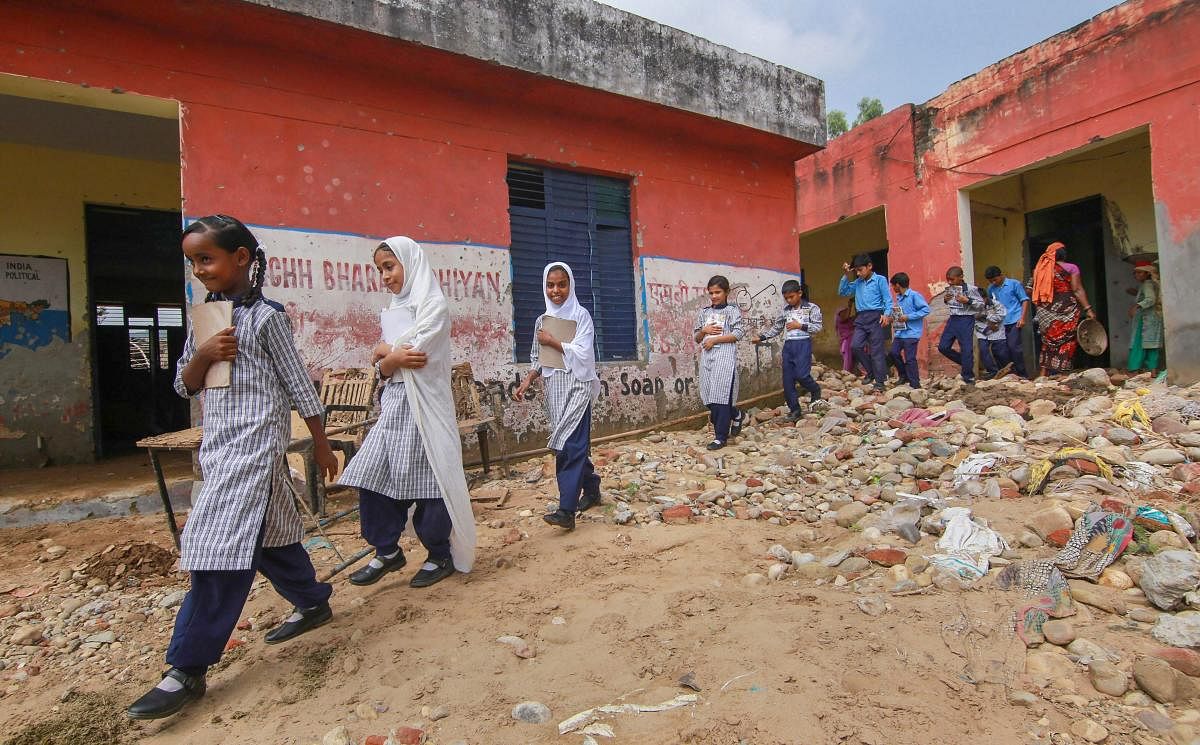 Students arrive to attend their classes at the flash flood-hit Government School Seri Kalan at Nagrota on the outskirts of Jammu on Wednesday, Aug 29, 2018. PTI