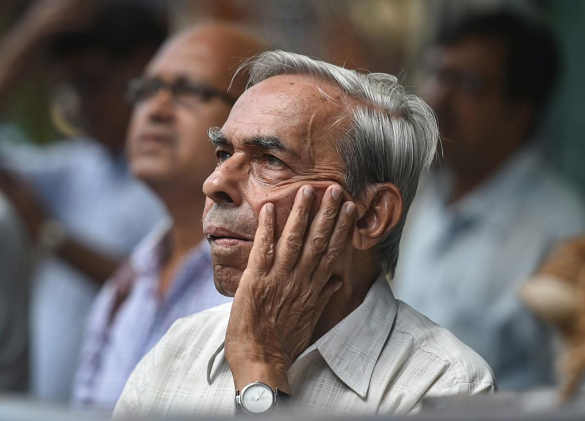 People react as they watch the rate of the Indian rupee against US dollar at a display board on the facade of Bombay Stock Exchange in Mumbai on Thursday, Aug 30, 2018. The rupee weakened to 70.84 against US Dollar on Thursday. PTI