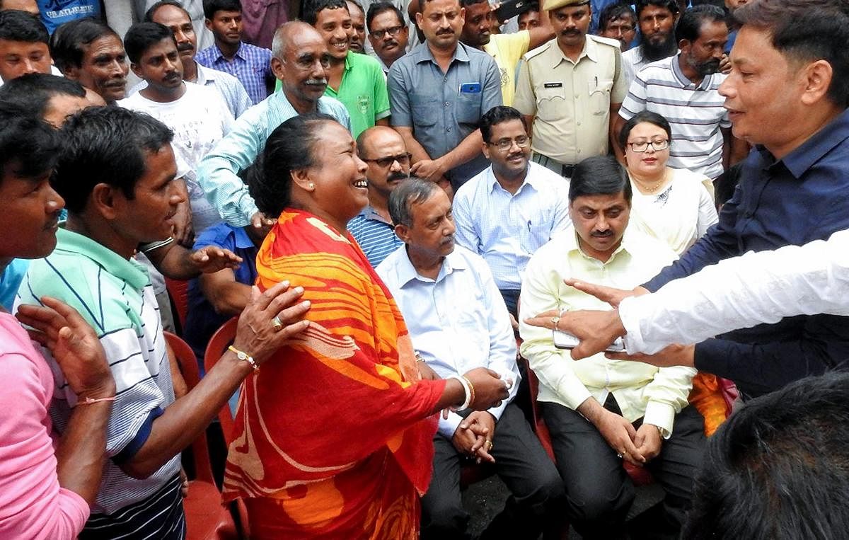 Basana Barman (C), mother of heptathlete Swapna Barman, rejoices as her villagers congratulate her, in Jalpaiguri on Thursday, Aug 30, 2018. Barman delivered a gold-winning performance in the Heptathlon event at Asian Games yesterday. PTI