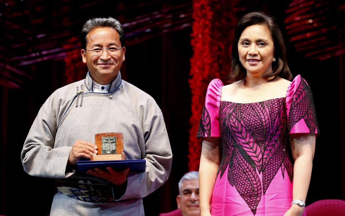 Ramon Magsaysay awardee Sonam Wangchuk, left, from India, holds his award as he pposes with Vice-president Leni Robredo during ceremony at the Cultural Center of the Philippines, Friday, Aug. 31, 2018 in Manila, Philippines. The Magsaysay awards is Asia's equivalent to the Nobel Prize and was established in 1958 in honor of the country's President Ramon Magsaysay who died in a plane crash. AP/ PTI