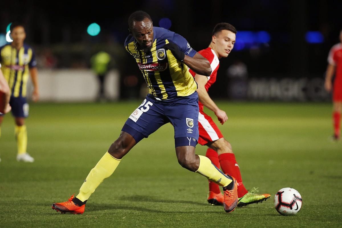 Usain Bolt overruns the ball during a friendly trial match between the Central Coast Mariners and the Central Coast Select in Gosford, Australia, Friday, Aug. 31, 2018. Bolt, who holds the world records for the 100- and 200-meter sprints and is an eight-time Olympic gold medalist, is hoping to earn a contract with the Mariners for the 2018-19 season in Australia's top-flight competition. AP/PTI