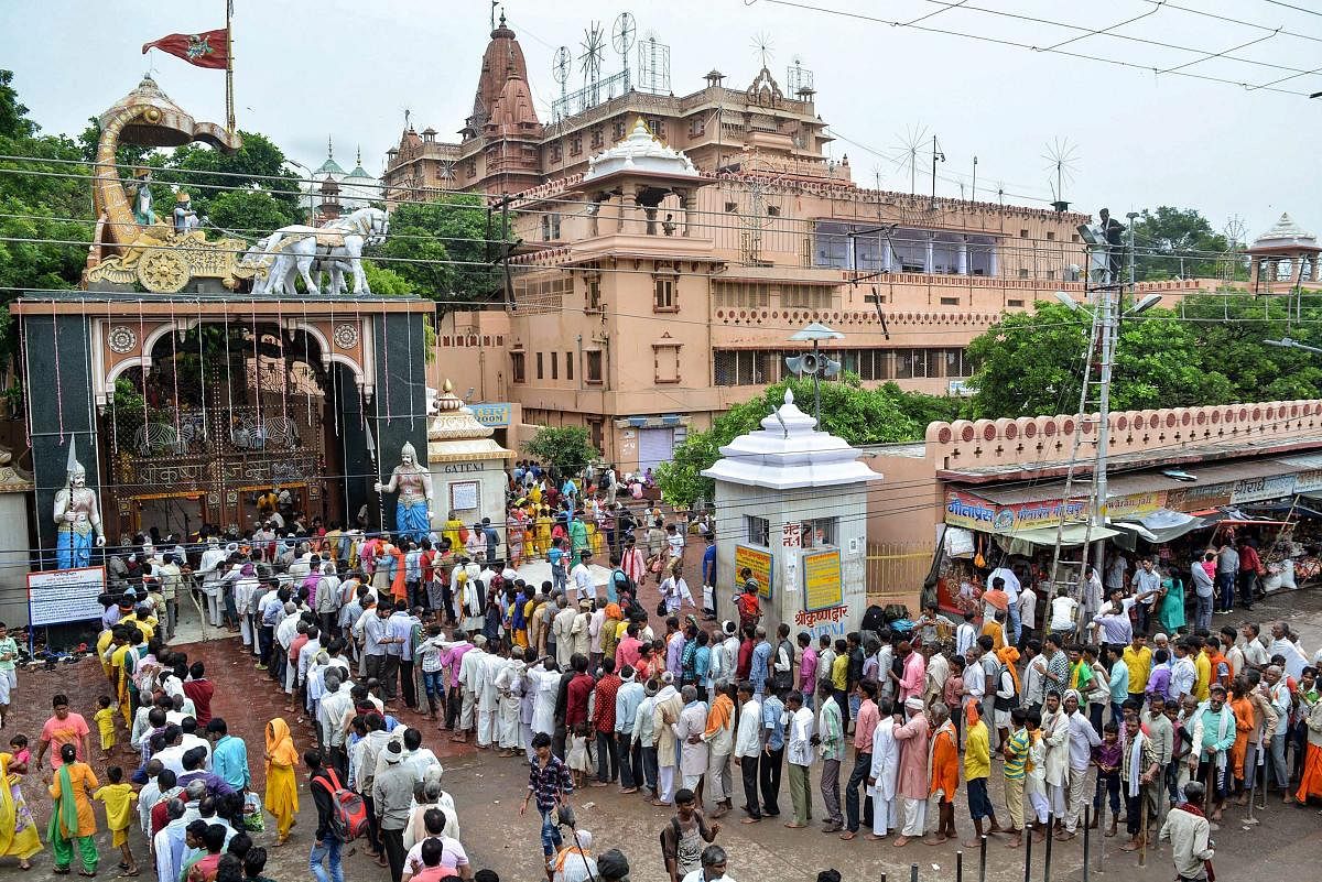 Devotees stand in a queue to offer prayers at Krishna Janamsthan temple on the eve of Janmashtmi festival, in Mathura on Saturday, Sept 1, 2018. (PTI Photo)