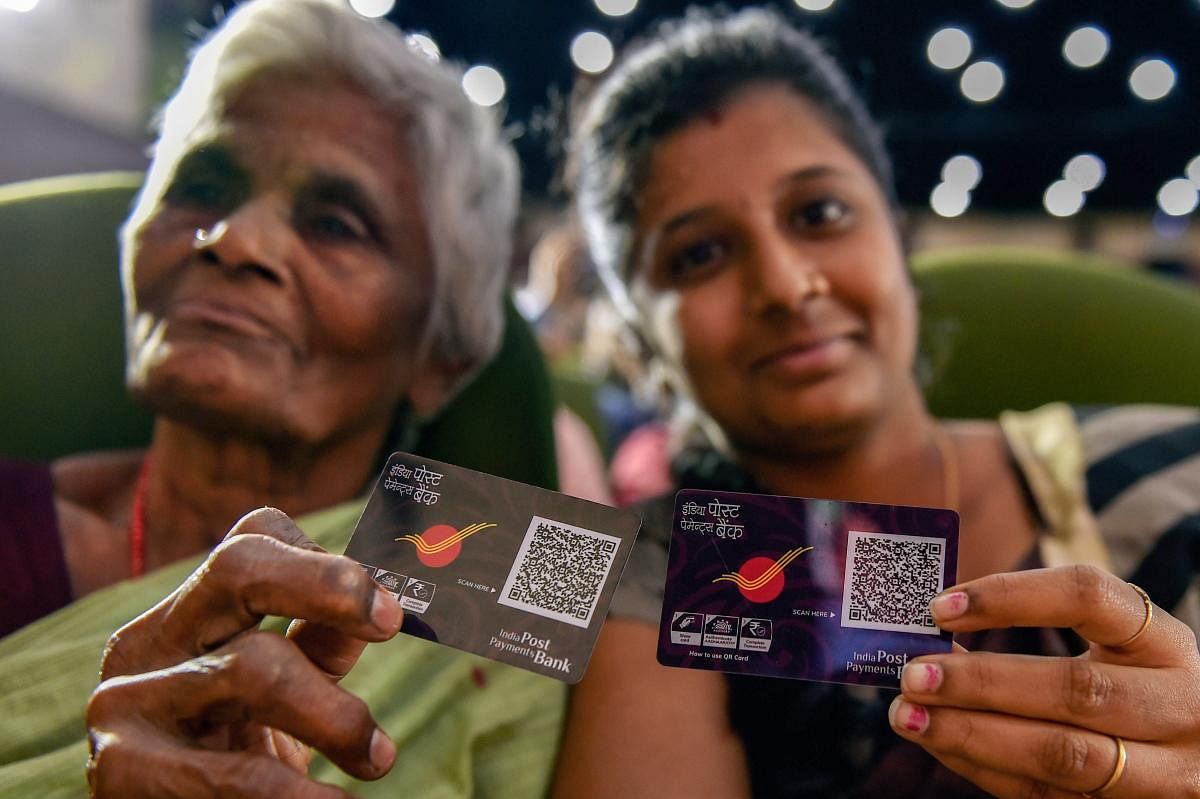 Beneficiaries display their digital QR code at the launch of 'India Post Payments Bank' (IPPB), in Chennai on Saturday, Sept 1, 2018. (PTI Photo)