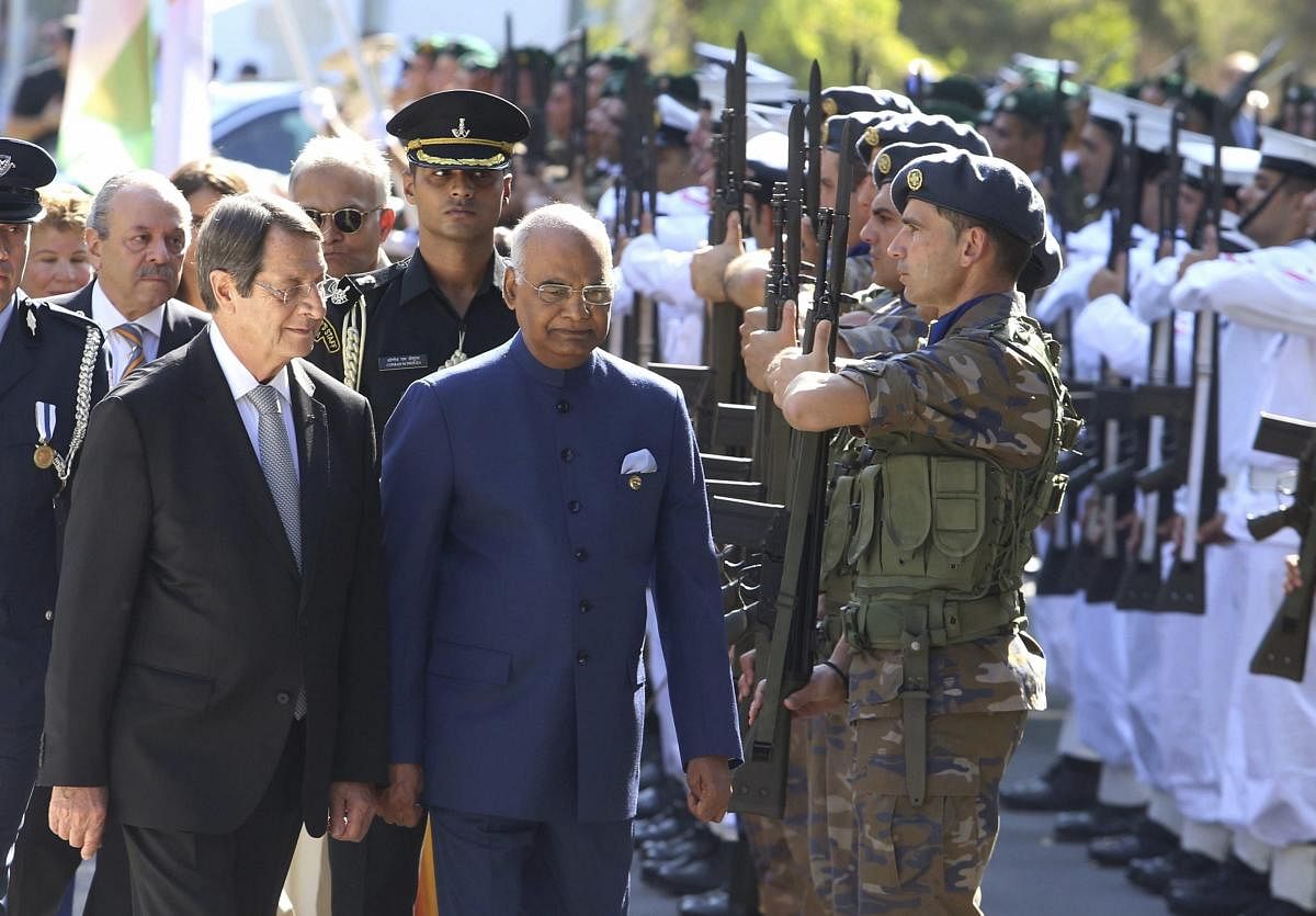India President Ram Nath Kovind, center, and Cyprus' President Nicos Anastasiades, left, review a military guard of honor during a welcoming ceremony at the presidential palace in capital Nicosia, Cyprus, Monday, Sept. 3, 2018. India President Ram Nath Kovind is on a two-day visit to Cyprus. AP/PTI