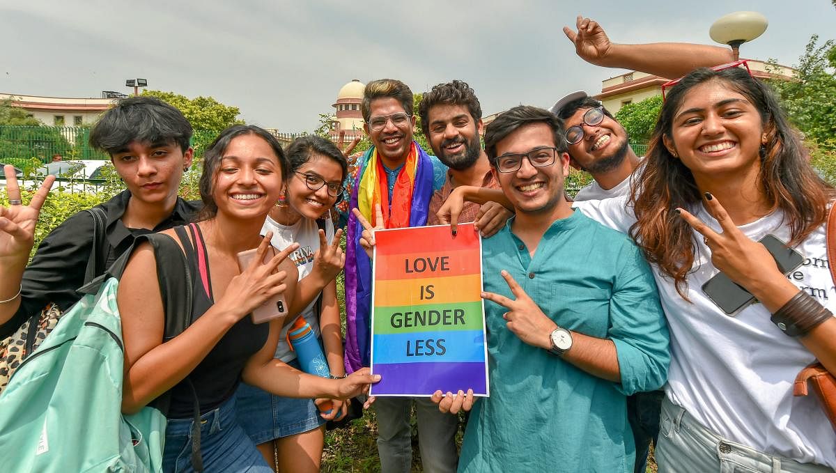 People react after the Supreme Court verdict which decriminalises consensual gay sex, outside the Supreme Court in New Delhi. (PTI Photo)