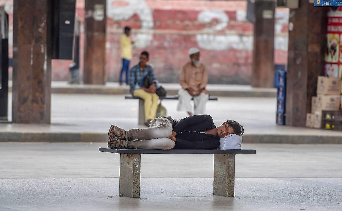 A commuter takes a nap at Majestic Bus Stand during 'Bharat Bandh' strike called by Congress and other parties against fuel price hike and depreciation of the rupee, in Bengaluru, Monday, Sept 10, 2018. PTI Photo