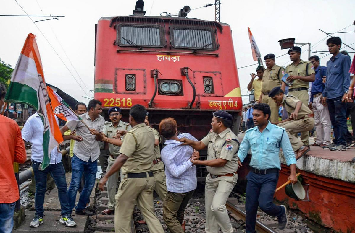 Police remove Congress workers from the railway tracks during their protest against fuel price hike in Asansol, Monday, September 10, 2018. (PTI Photo)