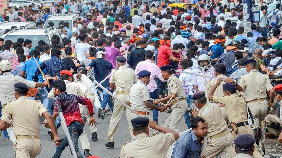 Patna: Akhil Bhartiya Bhumihar Brahmin Mahasabha activists clash with police personnel during their protest over the recent amendment of the SC/ST Act, in Patna, Friday, Sept 21, 2018. (PTI Photo)