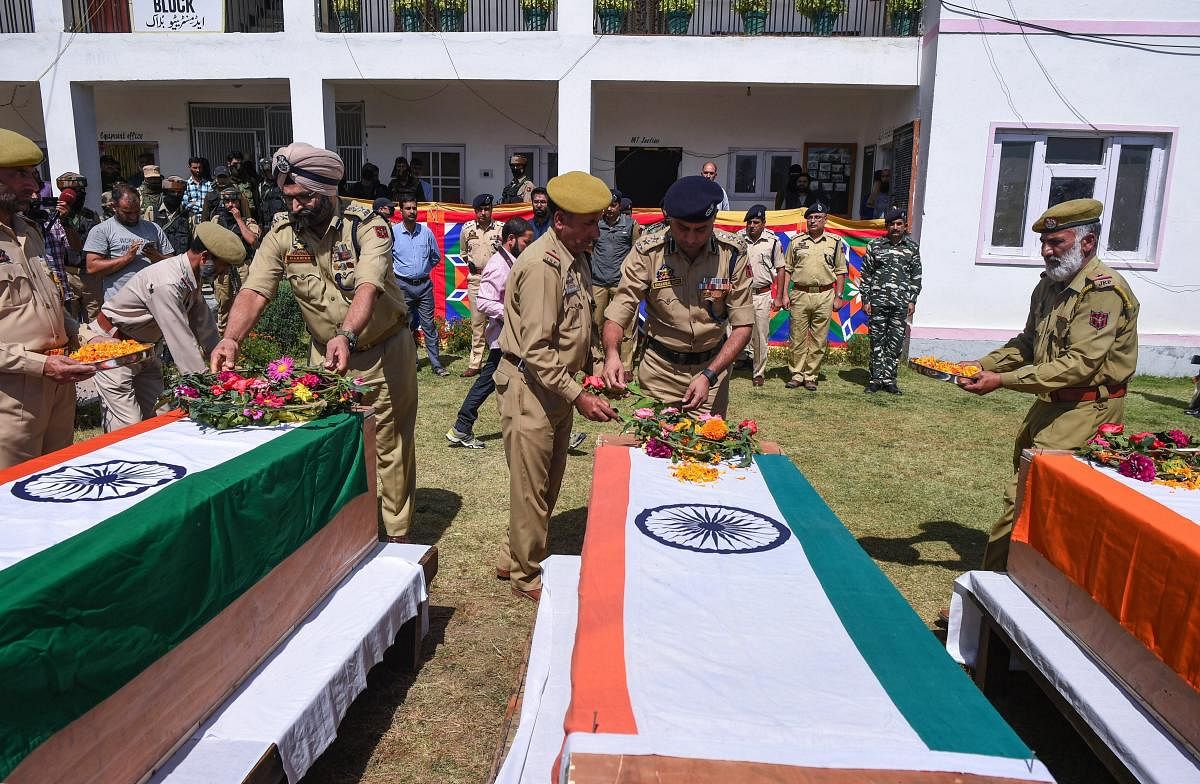 Shopian: Senior police officers pay tribute to a colleague, who was killed after being kidnapped by militants from his home, during a wreath laying ceremony in Shopian, Friday, September 21, 2018. The militants had abducted three SPOs and killed them later. (PTI Photo/S Irfan)