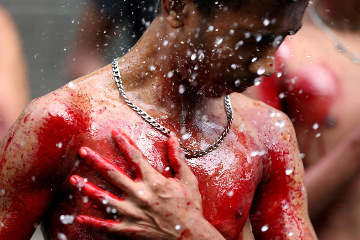 A Shi'ite muslim man bleeds after cutting himself while he takes part at the Ashura festival at a mosque in central Yangon, Myanmar September 21, 2018. REUTERS/Ann Wang