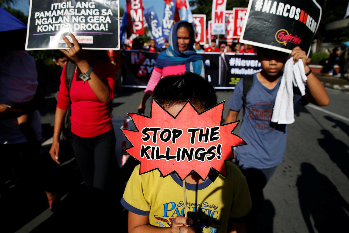 People display placards during a protest against the government of President Rodrigo Duterte on anniversary of the 1972 Martial Law declaration in Manila, in Philippines, September 21, 2018. REUTERS/Eloisa Lopez