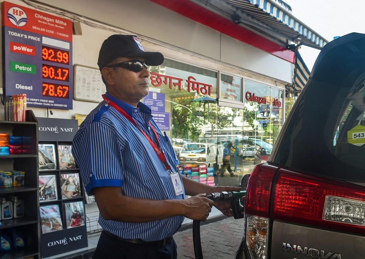 Mumbai: A filling station attendant assists a customer at a fuel station, in Mumbai, Monday, Sept 24, 2018. Petrol on Sept 21, 2018, crossed the Rs 90-mark in Mumbai as a dip in the value of rupee and rise in international oil prices pushed rates across the country to new all-time high. (PTI Photo/Mitesh Bhuvad)
