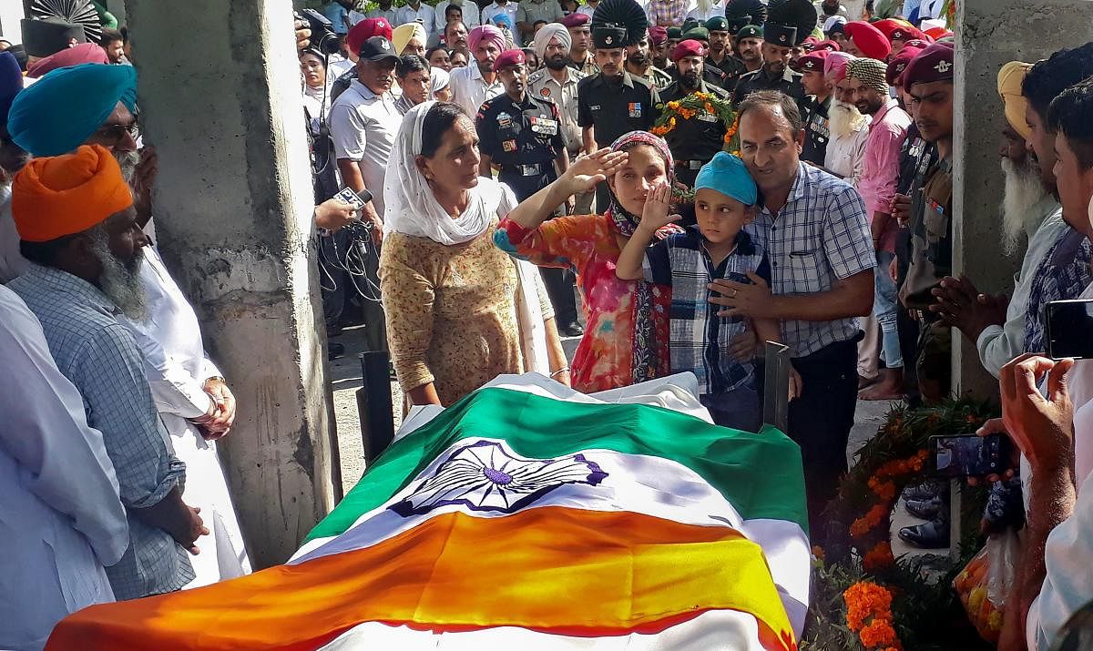 Gurdaspur: Family members pay their last respects to Lance Naik Sandeep Singh during his funeral at Kotla Khurd in Gurdaspur, Punjab, Tuesday, Sep. 25, 2018. Singh was killed Monday in Kupwara (J & K) in an encounter with militants. (PTI Photo)