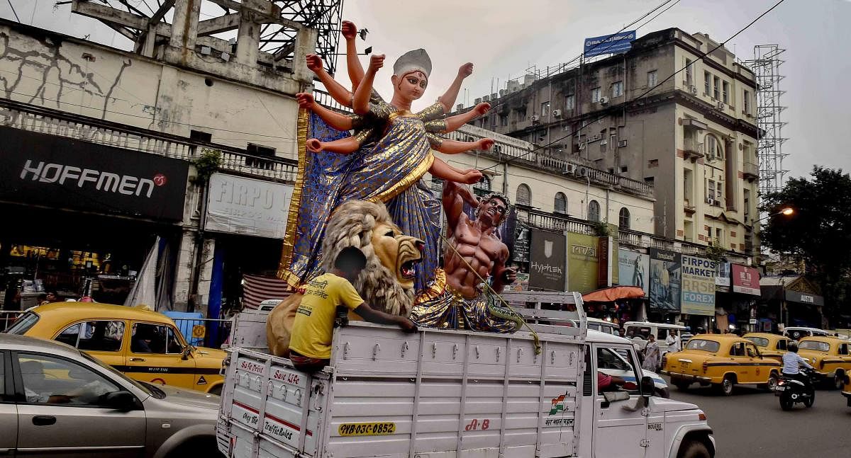 An idol of Goddess Durga is taken to a pandal for the installation ahead of Durga Puja festival in Kolkata. (PTI Photo)