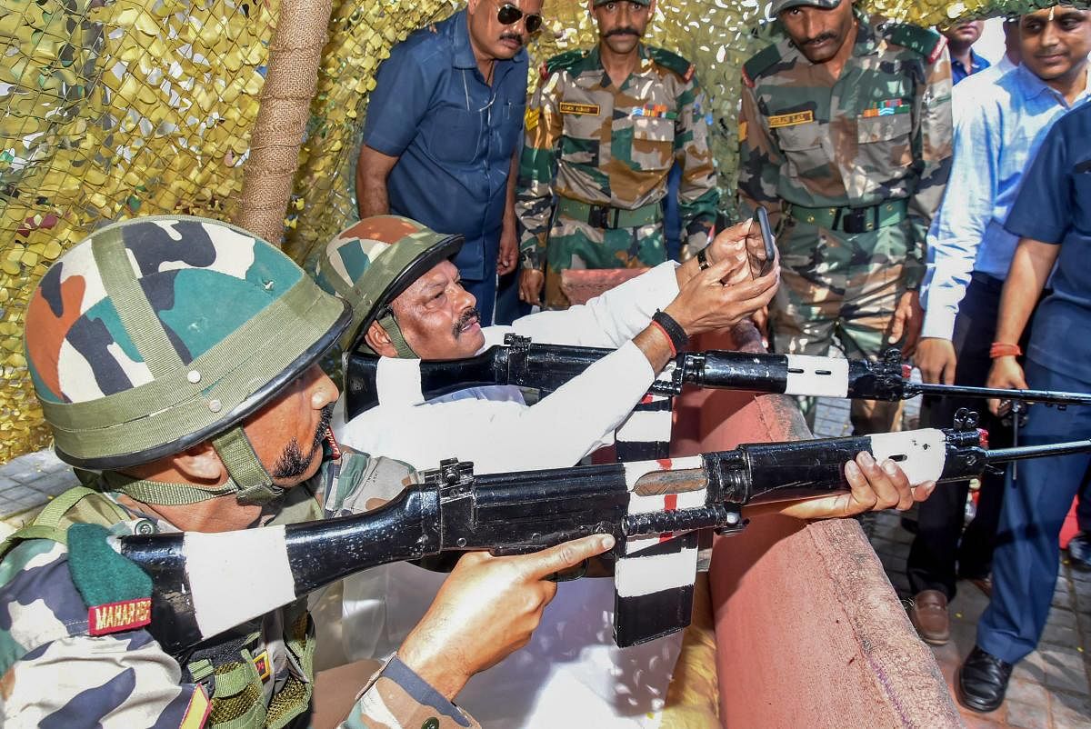 Jharkhand Chief Minister Raghubar Das takes selfie as he experiences an army weapon to commemorate 'Parakram Parv' at the Dipatoli War Memorial, in Ranchi. (PTI Photo)