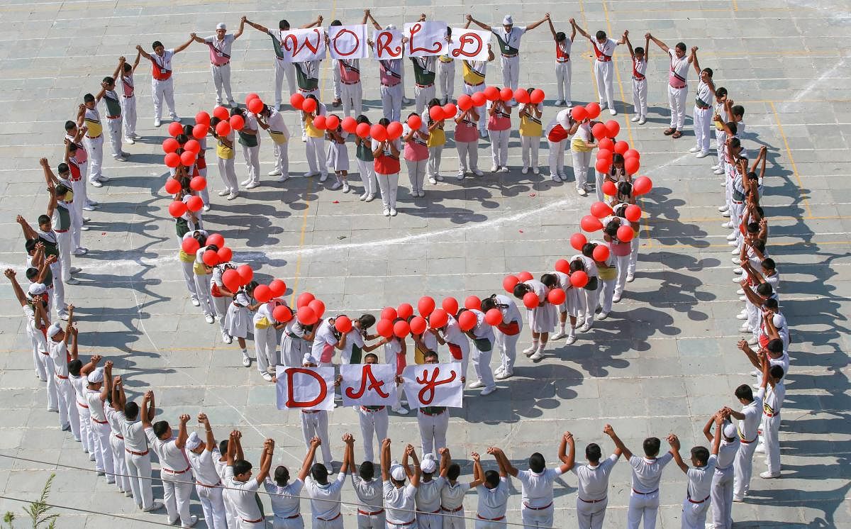 Students stand in a heart formation to commemorate World Heart Day, in Jammu. (PTI Photo)