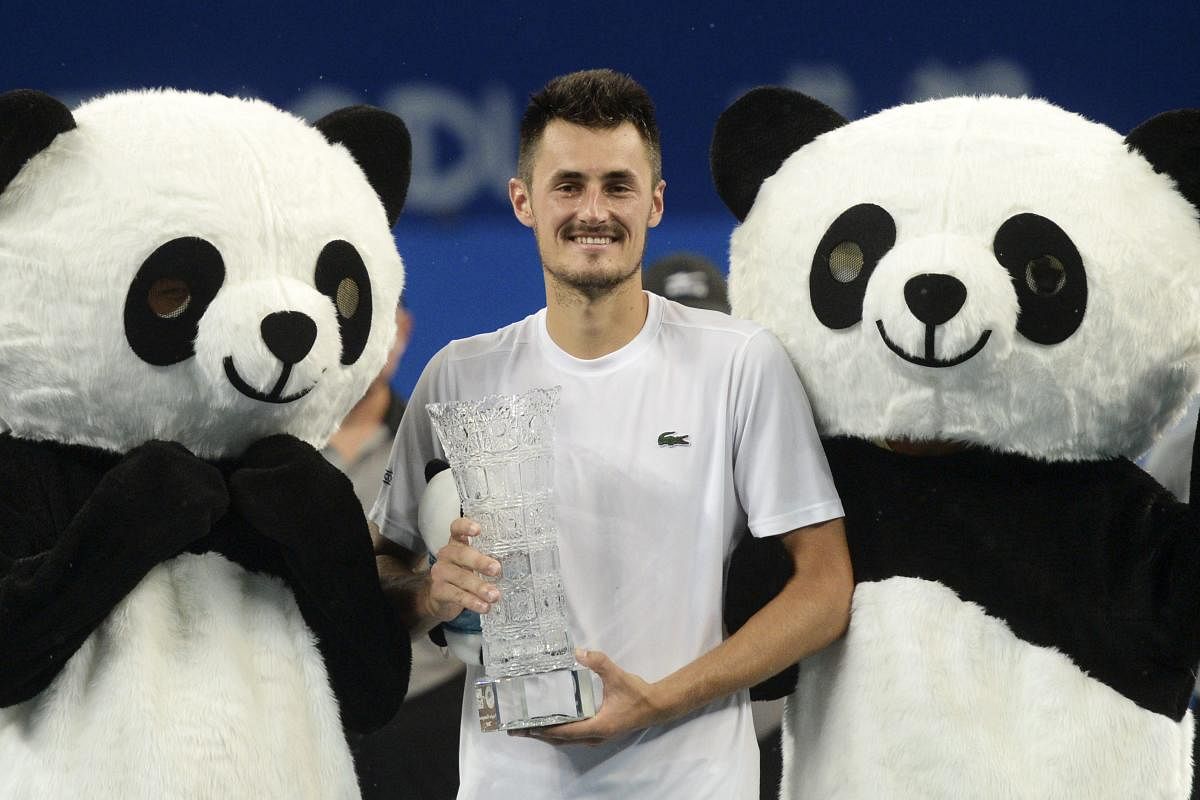 Bernard Tomic of Australia poses with his winning trophy after defeating Fabio Fognini of Italy in the men's singles final of the ATP Chengdu Open tennis tournament in Chengdu in China's southwest Sichuan province, Sunday, Sept. 30, 2018. (AP/PTI Photo)
