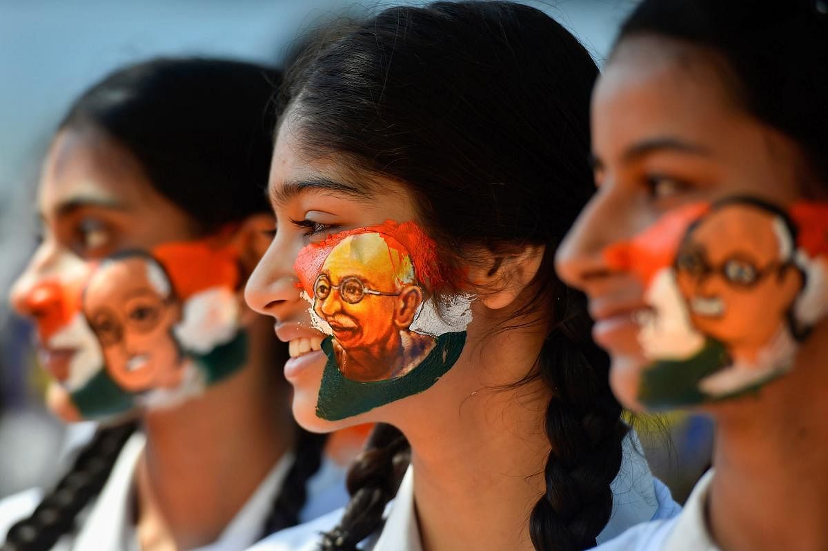 Students paint their face with Mahatma Gandhi image ahead of his birth anniversary, in Chennai, Monday Oct 01,2018. (PTI Photo)
