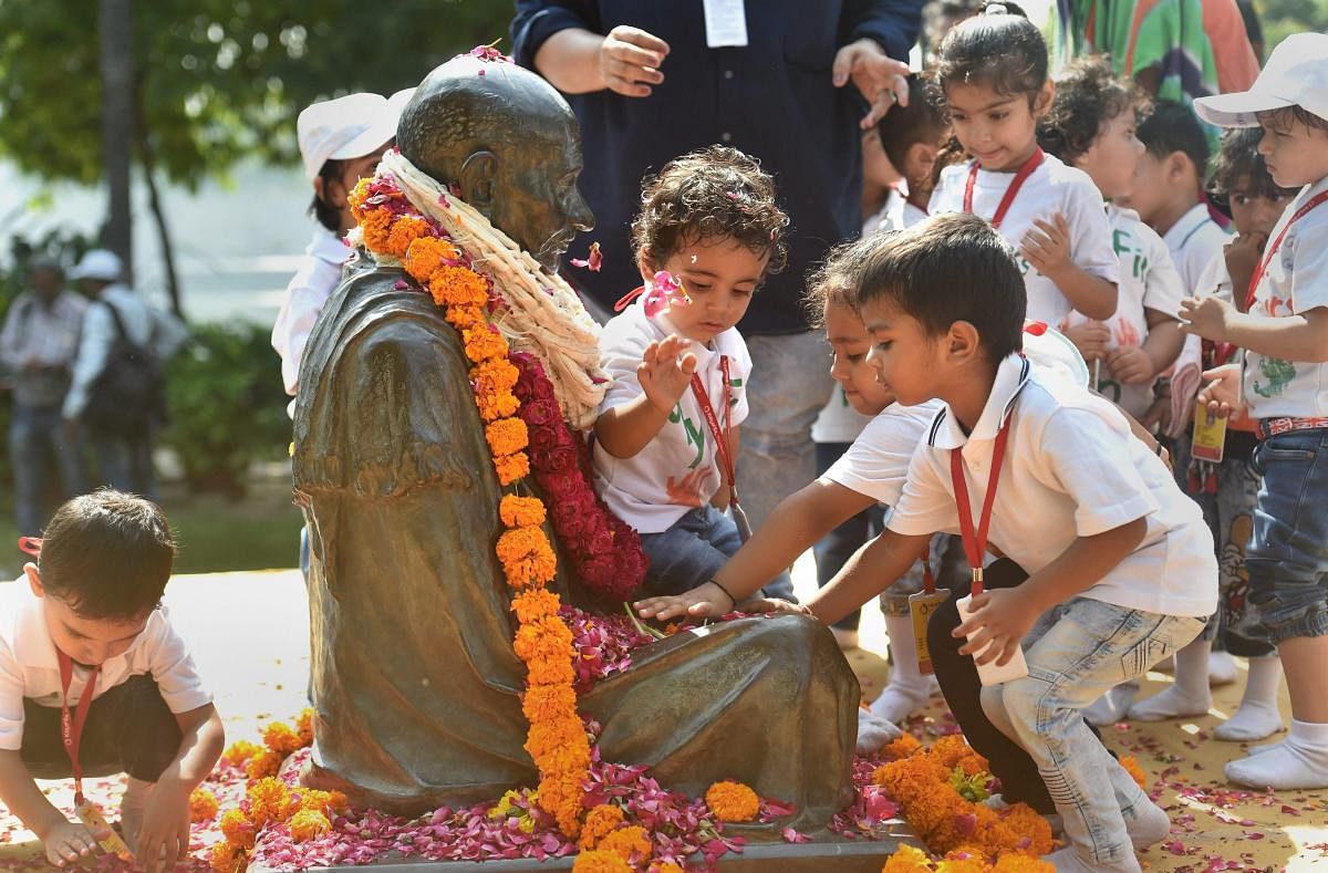 School students pay tribute to Mahatma Gandhi on his 149th birth anniversary, at Sabarmati Ashram in Ahmedabad. (PTI Photo)