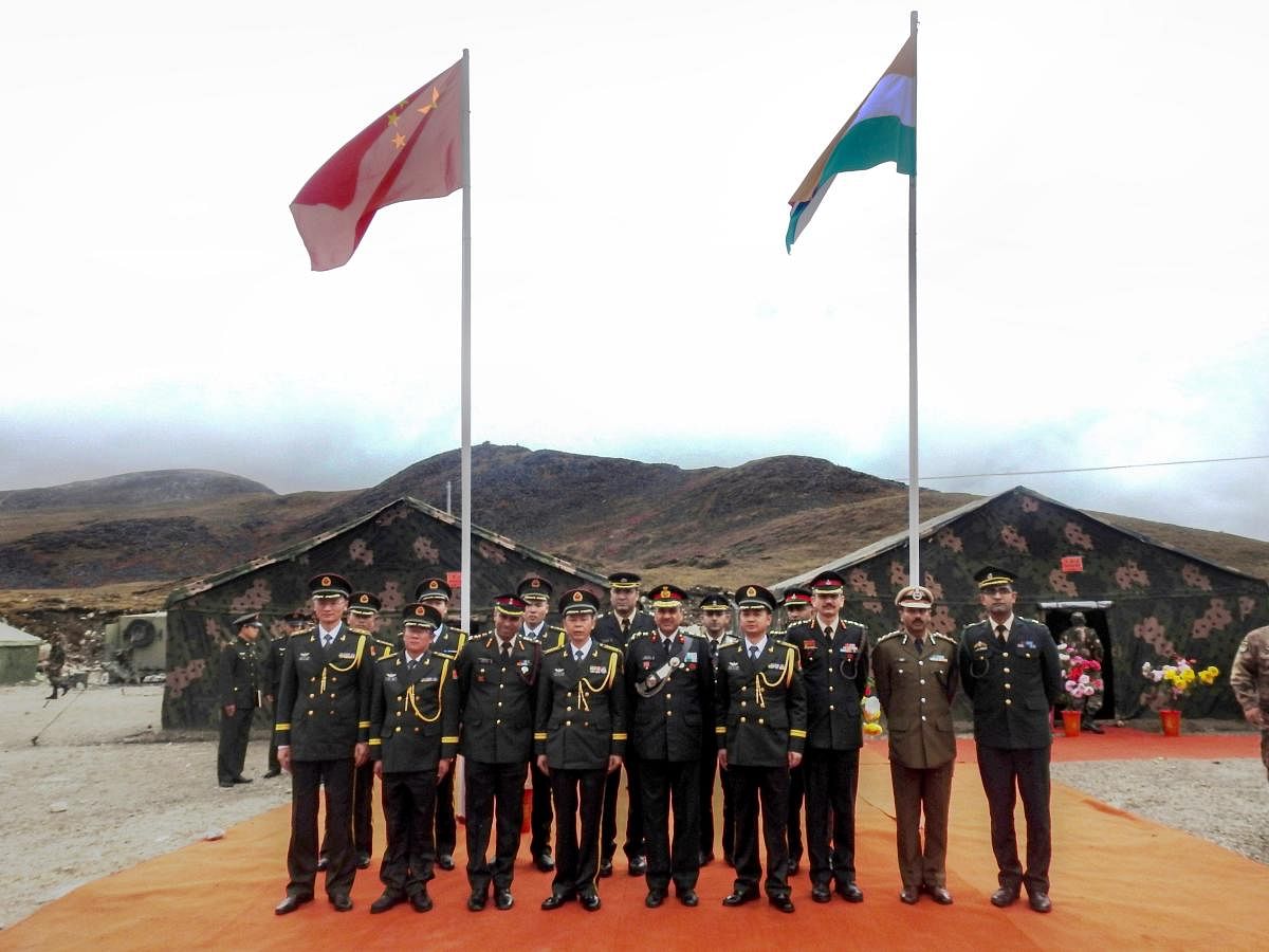 Indian and Chinese army officers exchange before a meeting on the occasion of National Day of China, at Bumla, the Line of Actual Control (LAC), Monday, Oct 1, 2018. (PTI Photo)