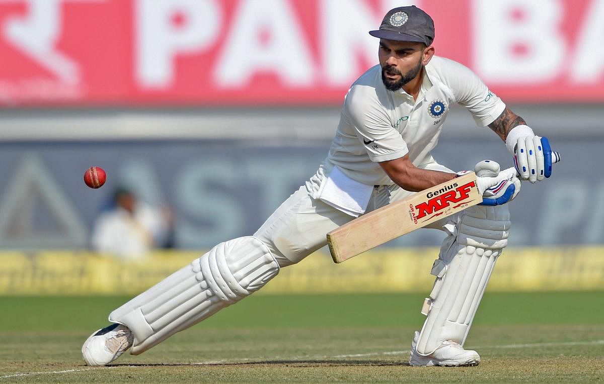 Virat Kohli plays a shot during the first test cricket match played between India and West Indies, in Rajkot. (PTI Photo)