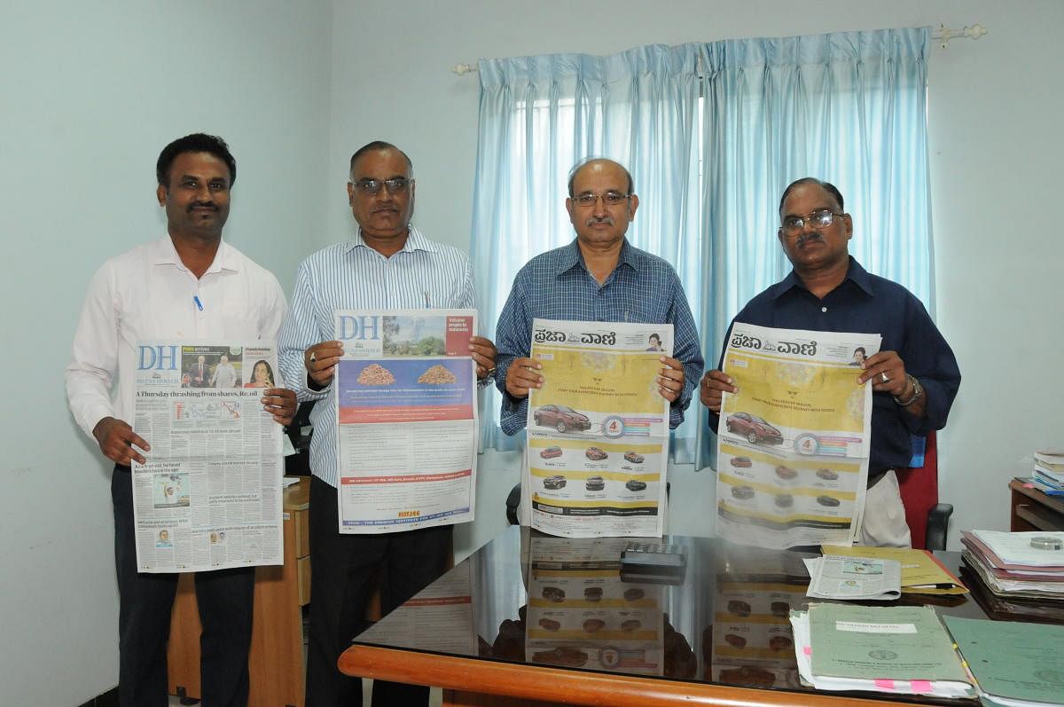 Chief accounts officer of All India Institute of Speech and Hearing K Purushotham, stores and purchase officer G H Ananda Ram, assistant accounts officer A N Prasad and publicity and information officer A R Keerthi release all pages colour edition of Deccan Herald and Prajavani in Mysuru on Friday. DH photo