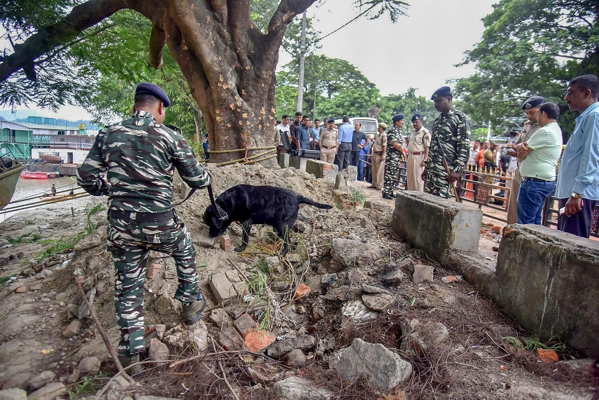 Army personnel inspect the site of a low-intensity bomb blast that took place at Panbazar in Guwahati. PTI