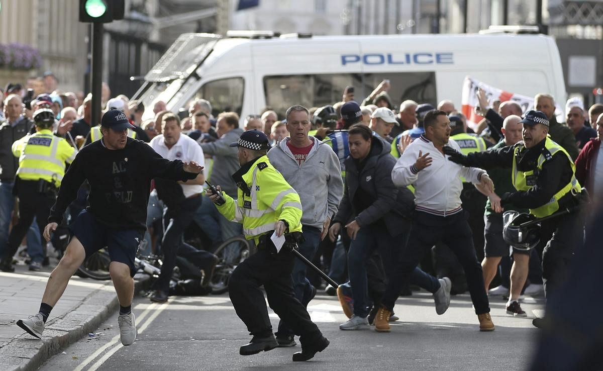 Police stop a breakaway from the main Football Lads alliance march, as they attempt to get close to a rival anti-facist demonstration in London. AP/PTI